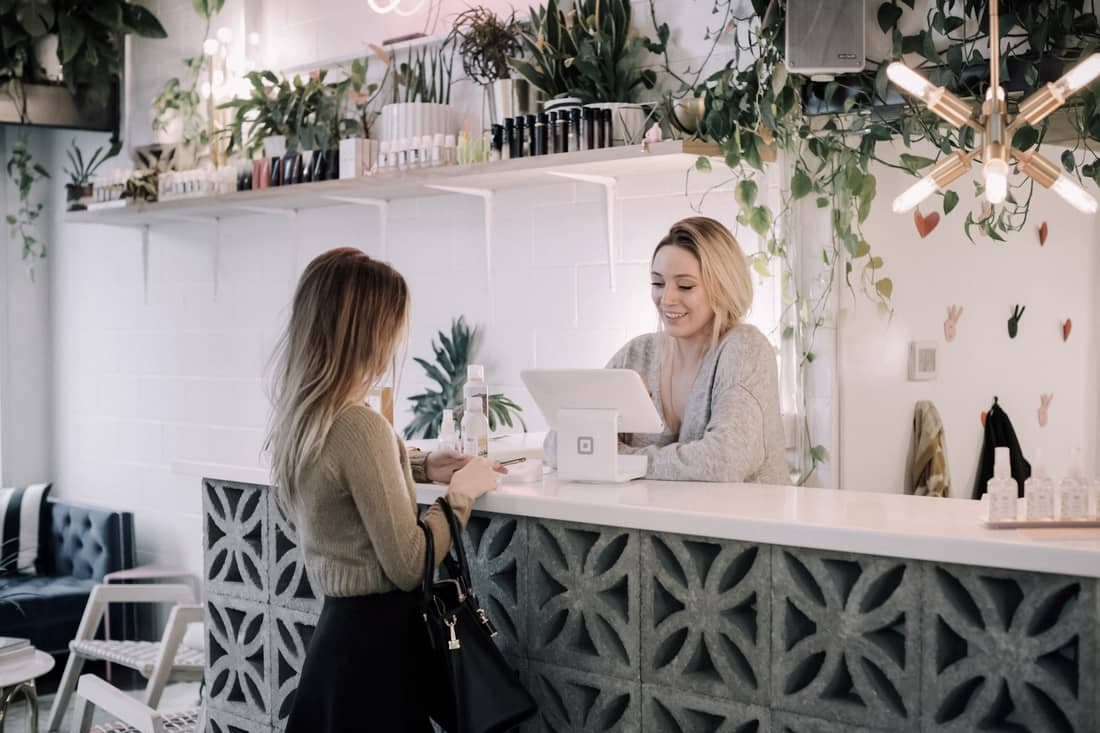 A small-business owner helping a customer at the counter